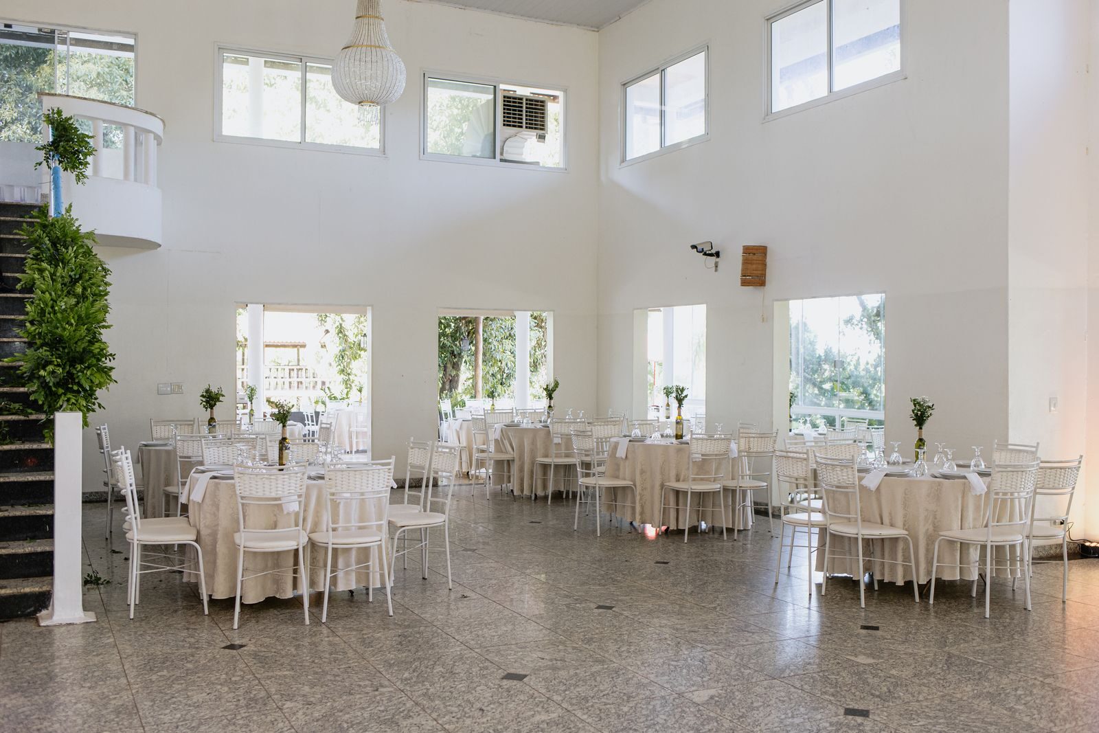 Beautiful indoor wedding reception venue set for a ceremony with elegant decor.